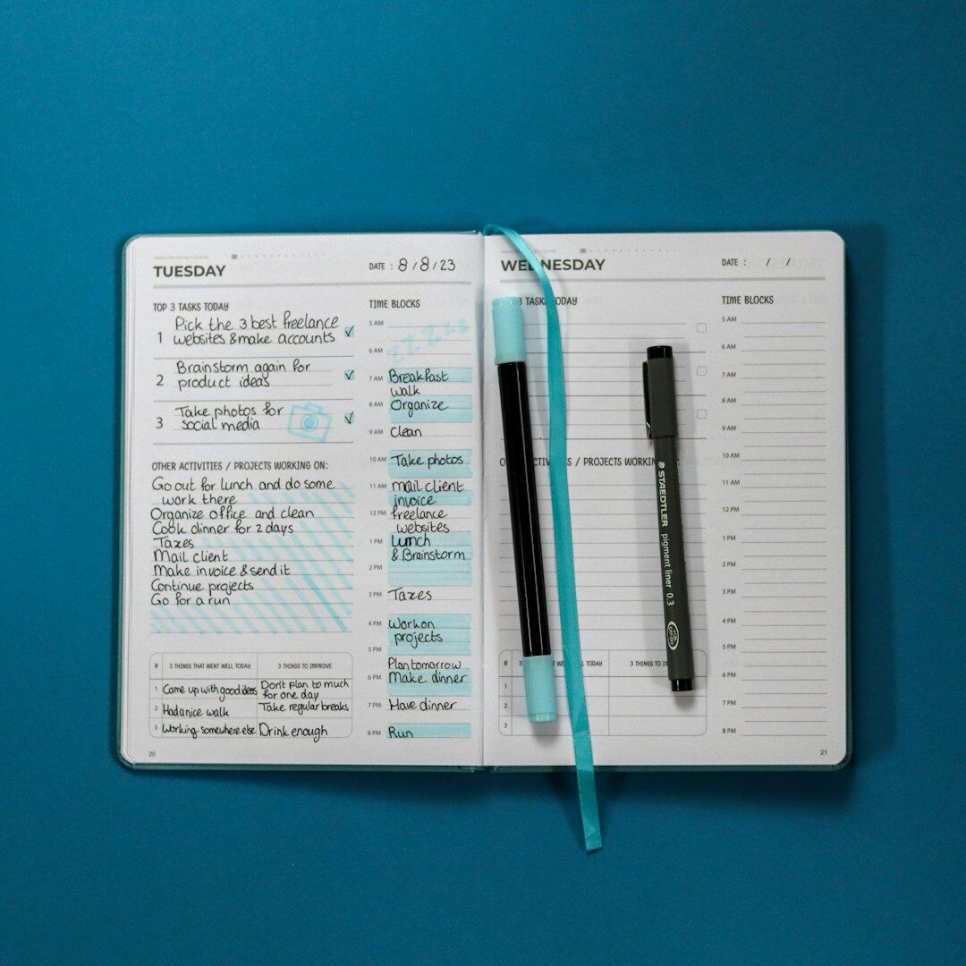 Close up of hands writing goals in a planner
