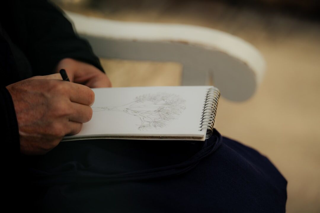 Brazilian woman writing personal goals in a notebook outdoors