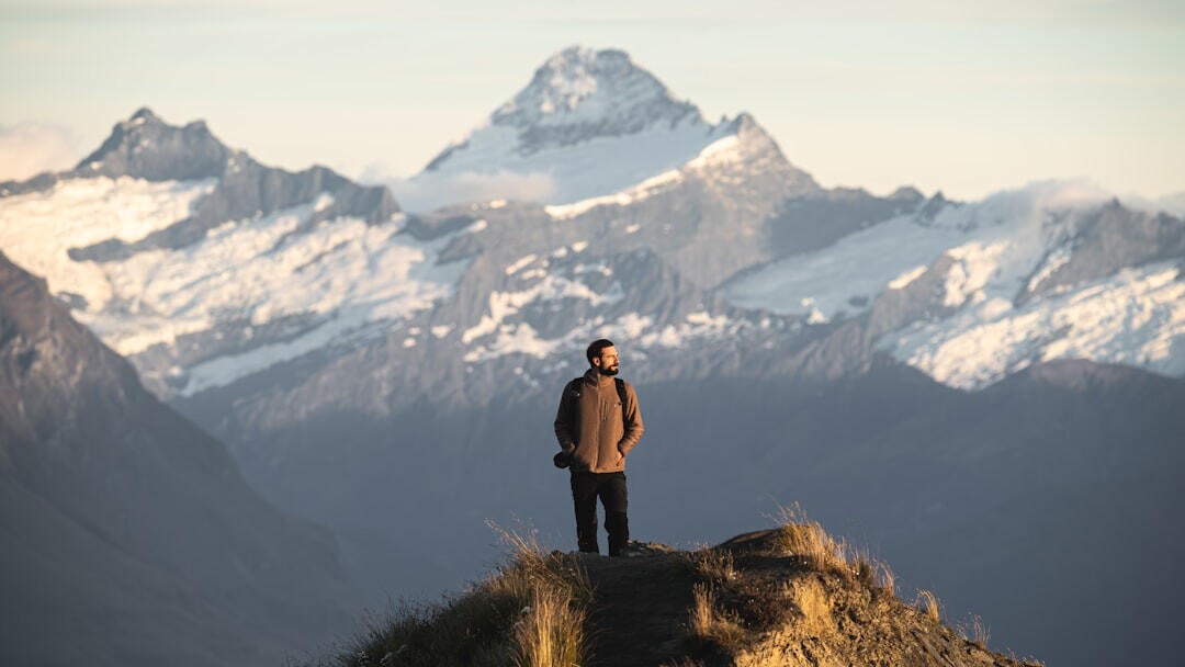 confident person standing on mountain peak
