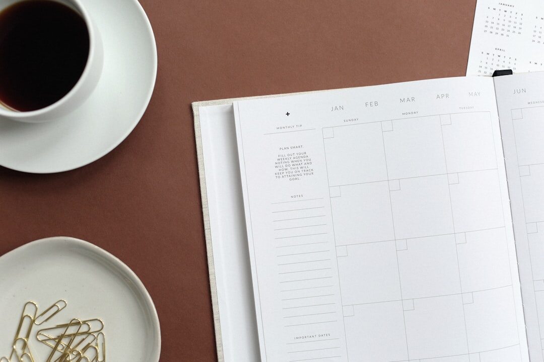 Overhead view of a planner, glasses and cup of tea on a table