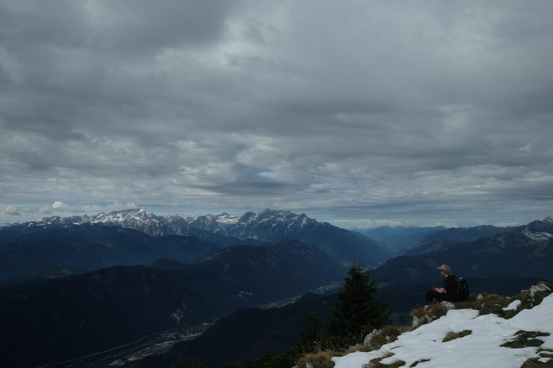 person climbing mountain peak
