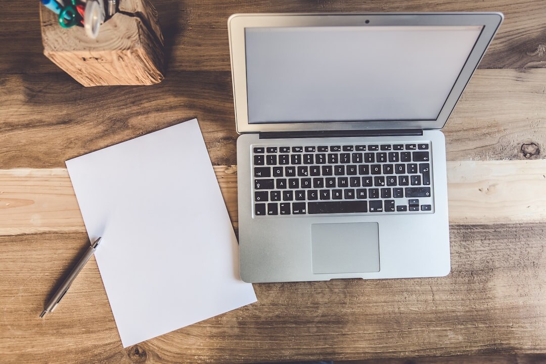 Open notebook and pen on a wooden desk