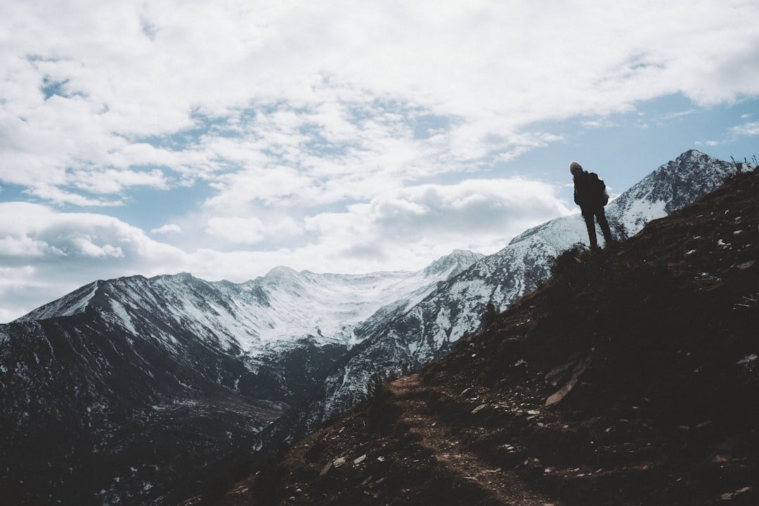 confident person standing on mountain peak