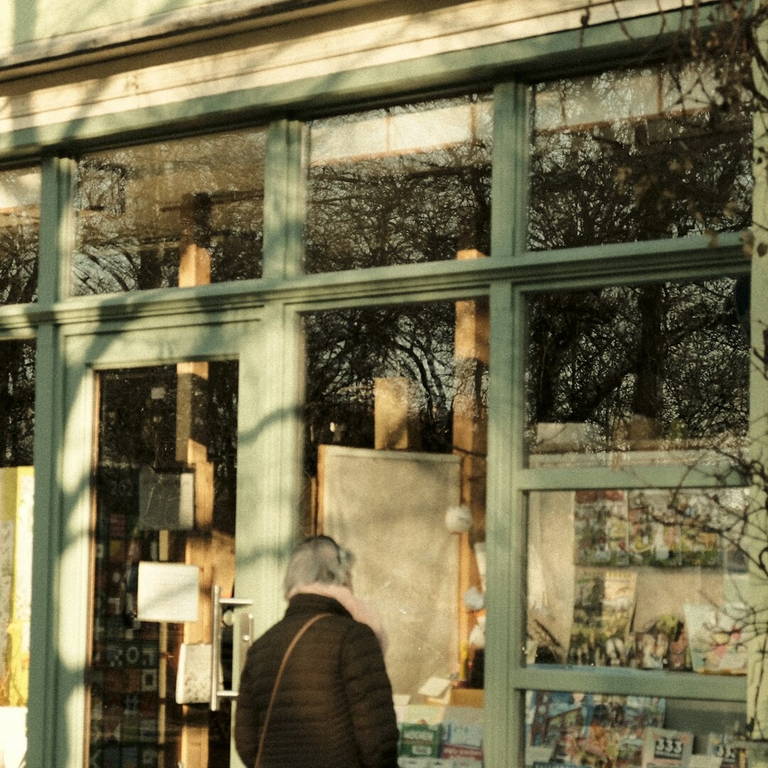 Brazilian man reading a book by the window